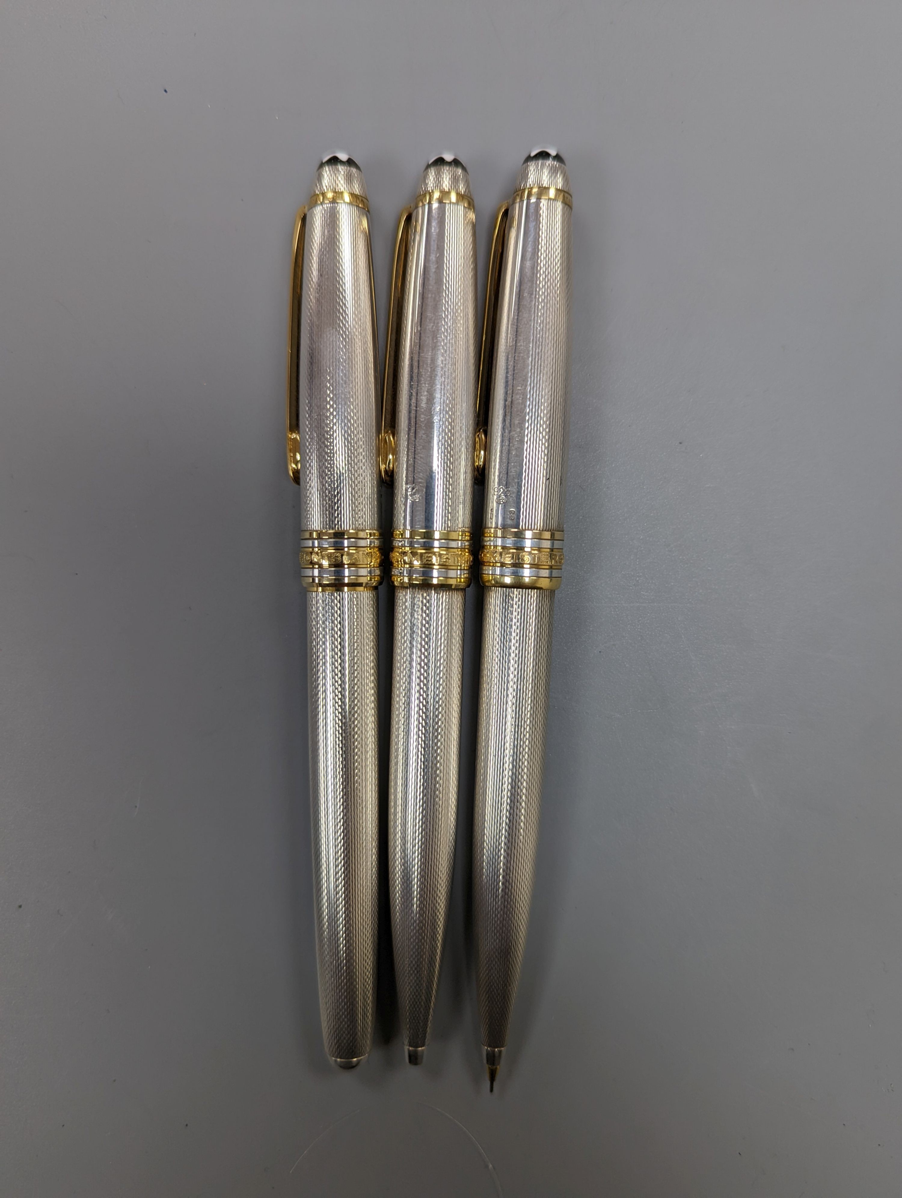 A modern suite of three silver Montblanc Meisterstuck ballpoint pens and pencil